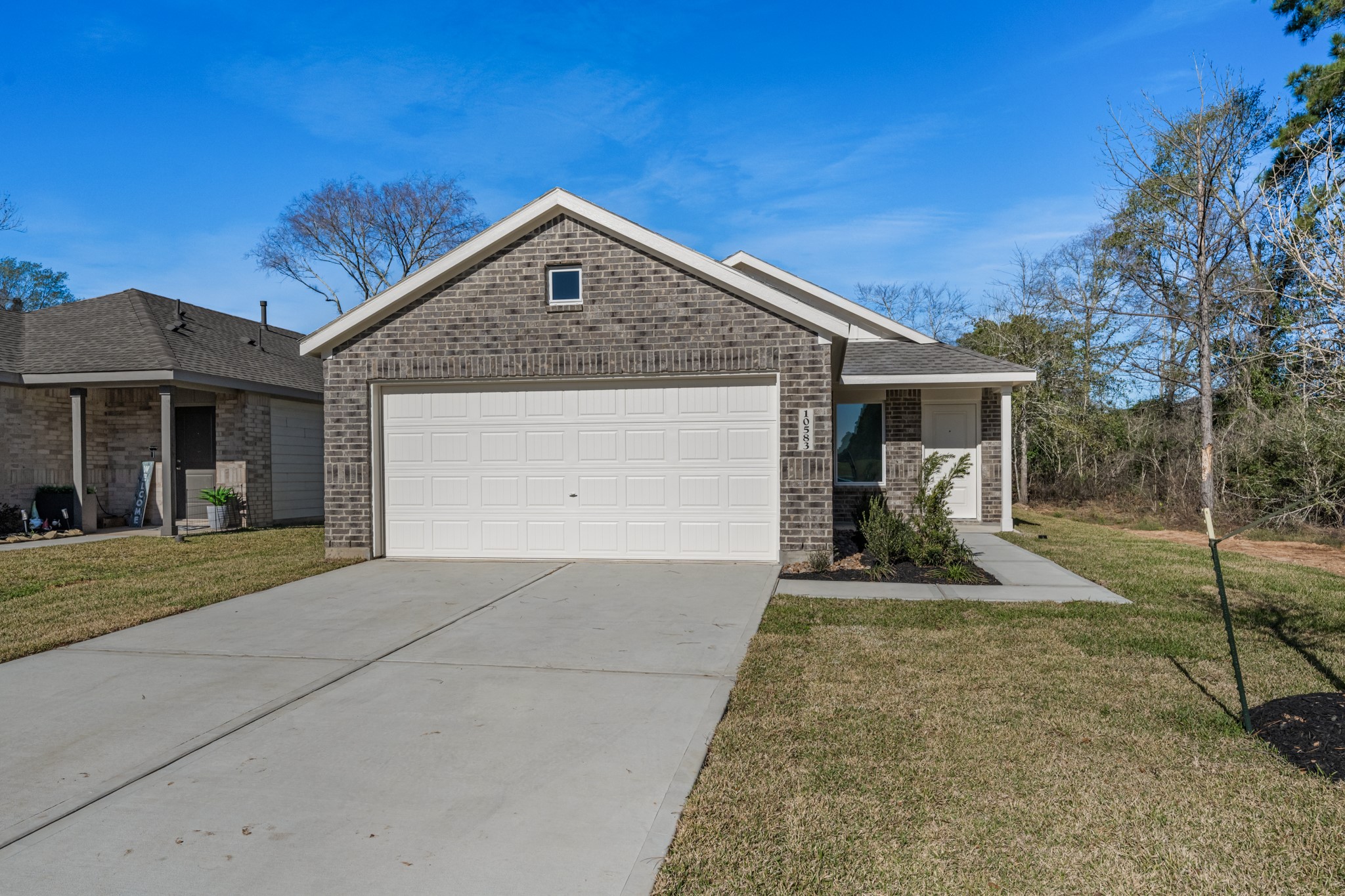 10583 Altitude Way Conroe, TX 77303 - Photo 2 of 33 front view of a house with a yard