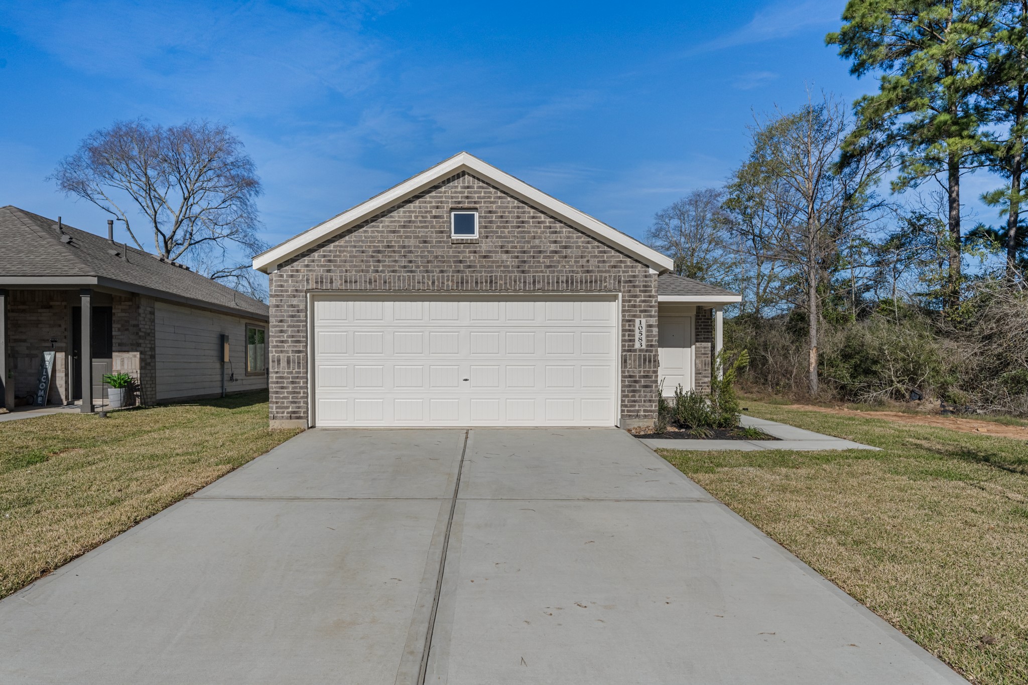 10583 Altitude Way Conroe, TX 77303 - Photo 3 of 33 a front view of a house with a yard and garage