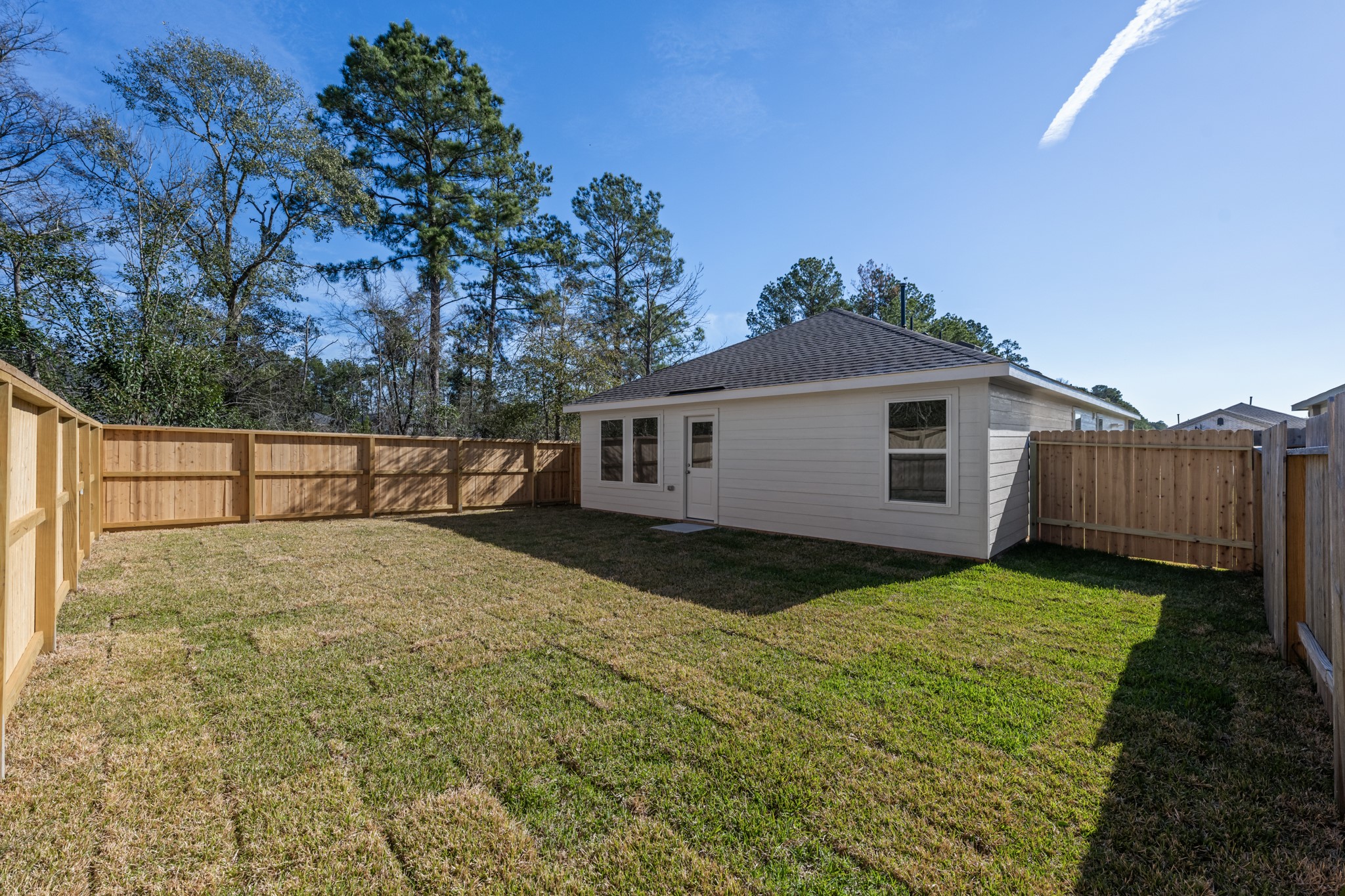 10583 Altitude Way Conroe, TX 77303 - Photo 32 of 33 a view of a yard in front of a house with wooden fence