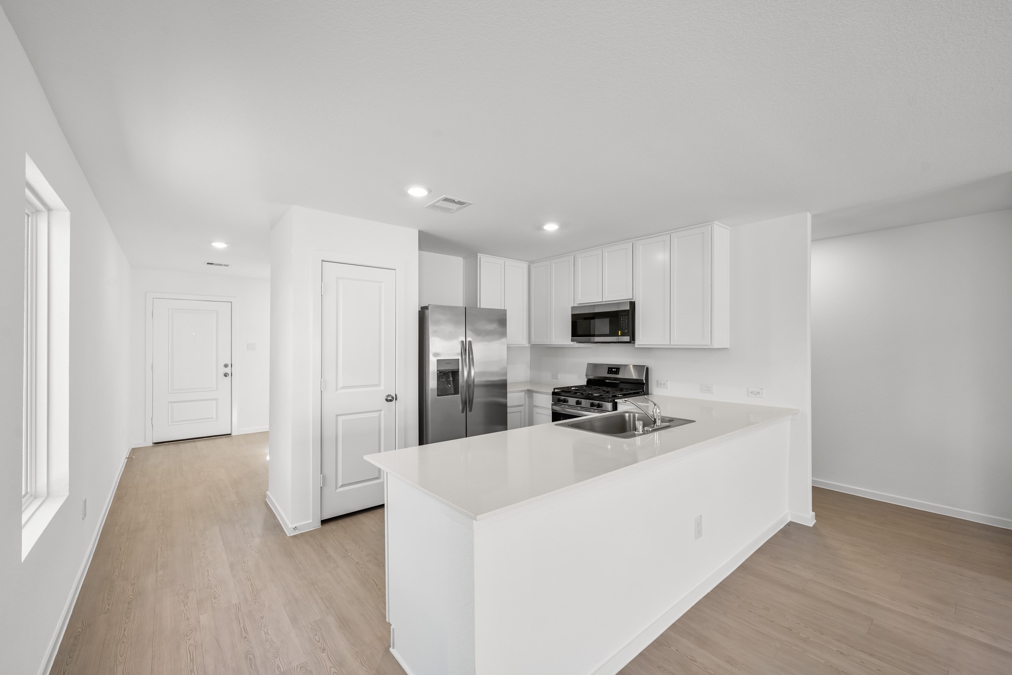 10583 Altitude Way Conroe, TX 77303 - Photo 6 of 33 a kitchen with stainless steel appliances a refrigerator sink and microwave