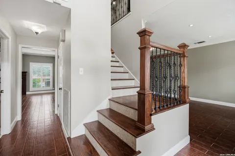 a view of entryway and hall with wooden floor