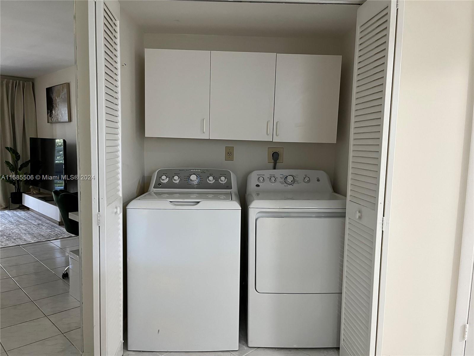 17801 North Bay Road, Unit 303 Sunny Isles Beach, FL 33160 - Photo 11 of 17 a utility room with dryer and washer