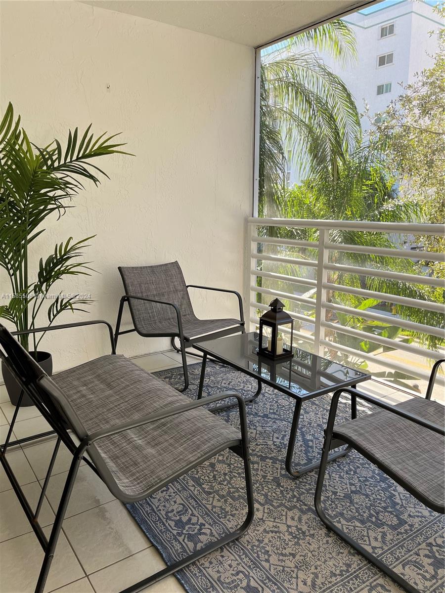 17801 North Bay Road, Unit 303 Sunny Isles Beach, FL 33160 - Photo 12 of 17 a outdoor living space with furniture