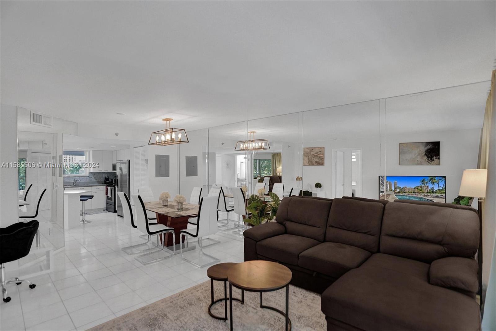 17801 North Bay Road, Unit 303 Sunny Isles Beach, FL 33160 - Photo 6 of 17 a living room with furniture and a view of kitchen