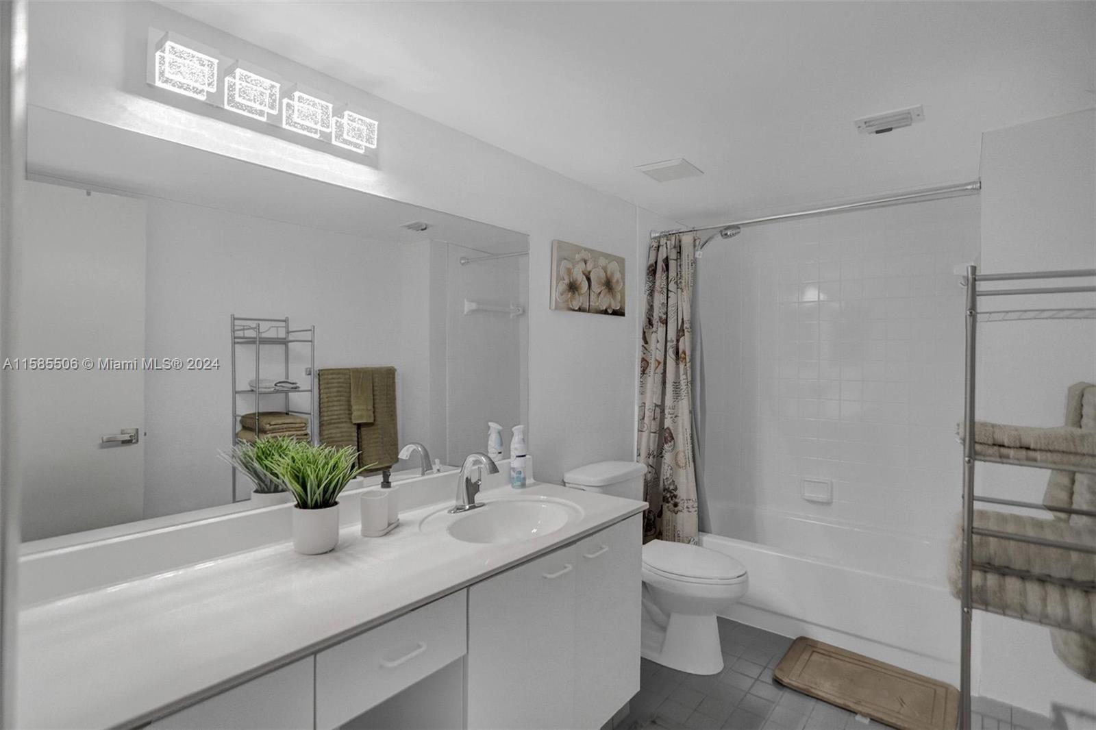 17801 North Bay Road, Unit 303 Sunny Isles Beach, FL 33160 - Photo 8 of 17 a bathroom with a granite countertop sink a toilet and shower