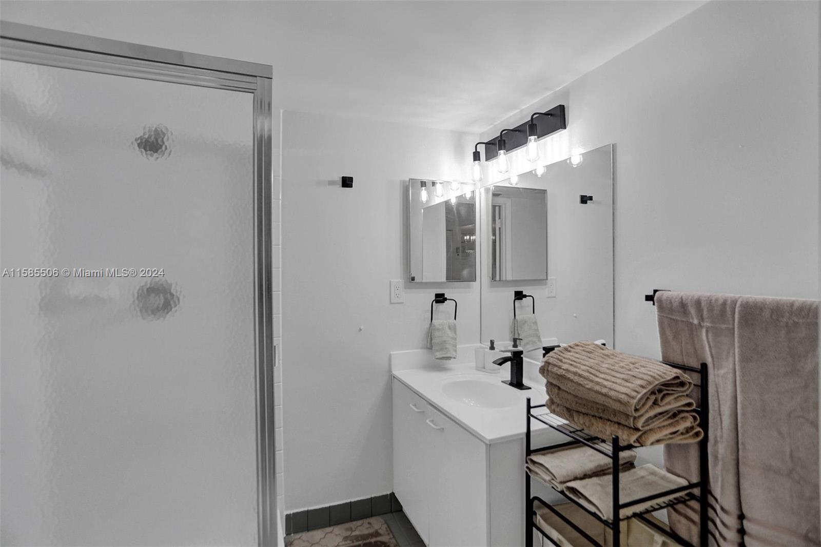 17801 North Bay Road, Unit 303 Sunny Isles Beach, FL 33160 - Photo 10 of 17 a bathroom with a mirror and a shower