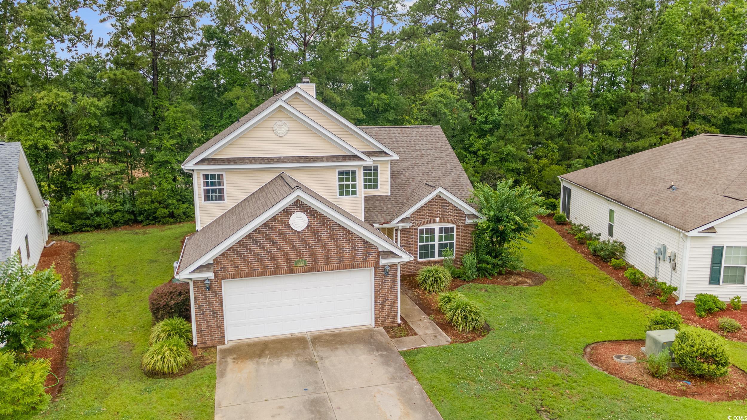 1033 Mccall Loop Conway, SC 29526 - Photo 3 of 40 Traditional-style home with brick siding, a chimne