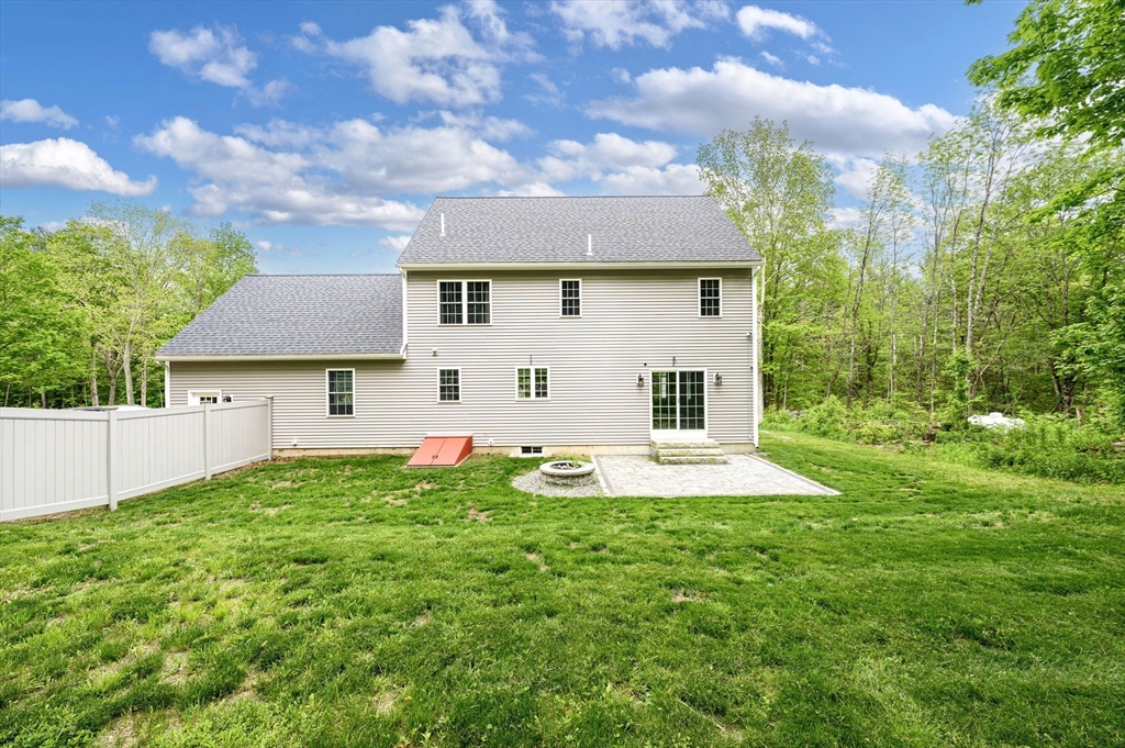 1310 North Brookfield Road Oakham, MA 01068 - Photo 9 of 30 a front view of a house with a yard