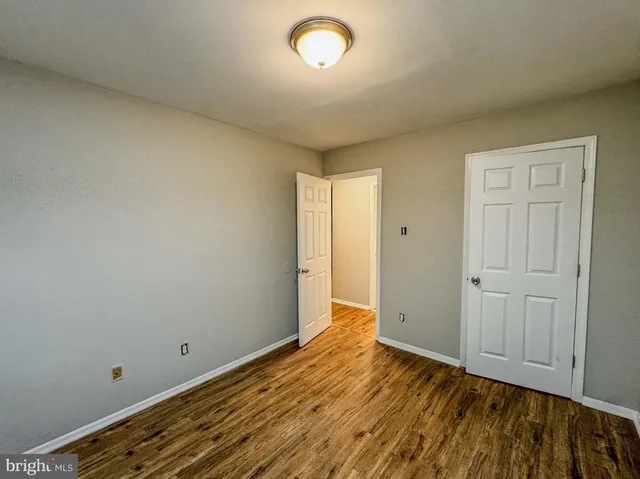 a view of room with wooden floor and window