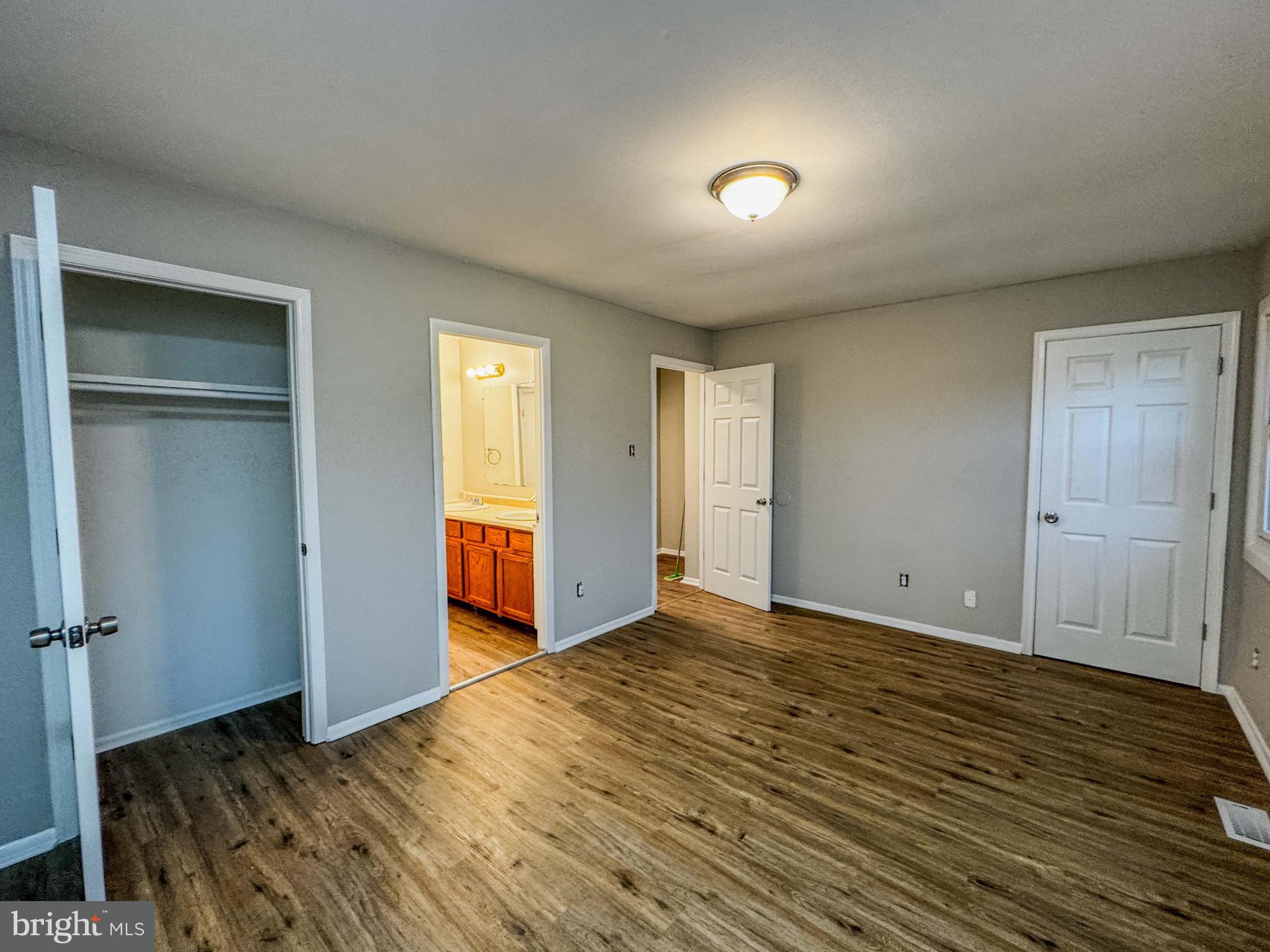 4 Milstone Court Sicklerville, NJ 08081 - Photo 18 of 23 a view of an empty room with wooden floor and a window