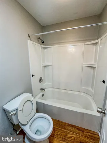 a bathroom with a toilet and a bathtub