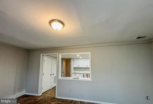 a view of room with window and wooden floor