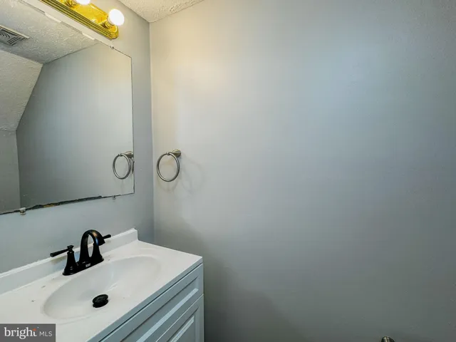 a bathroom with a sink and mirror