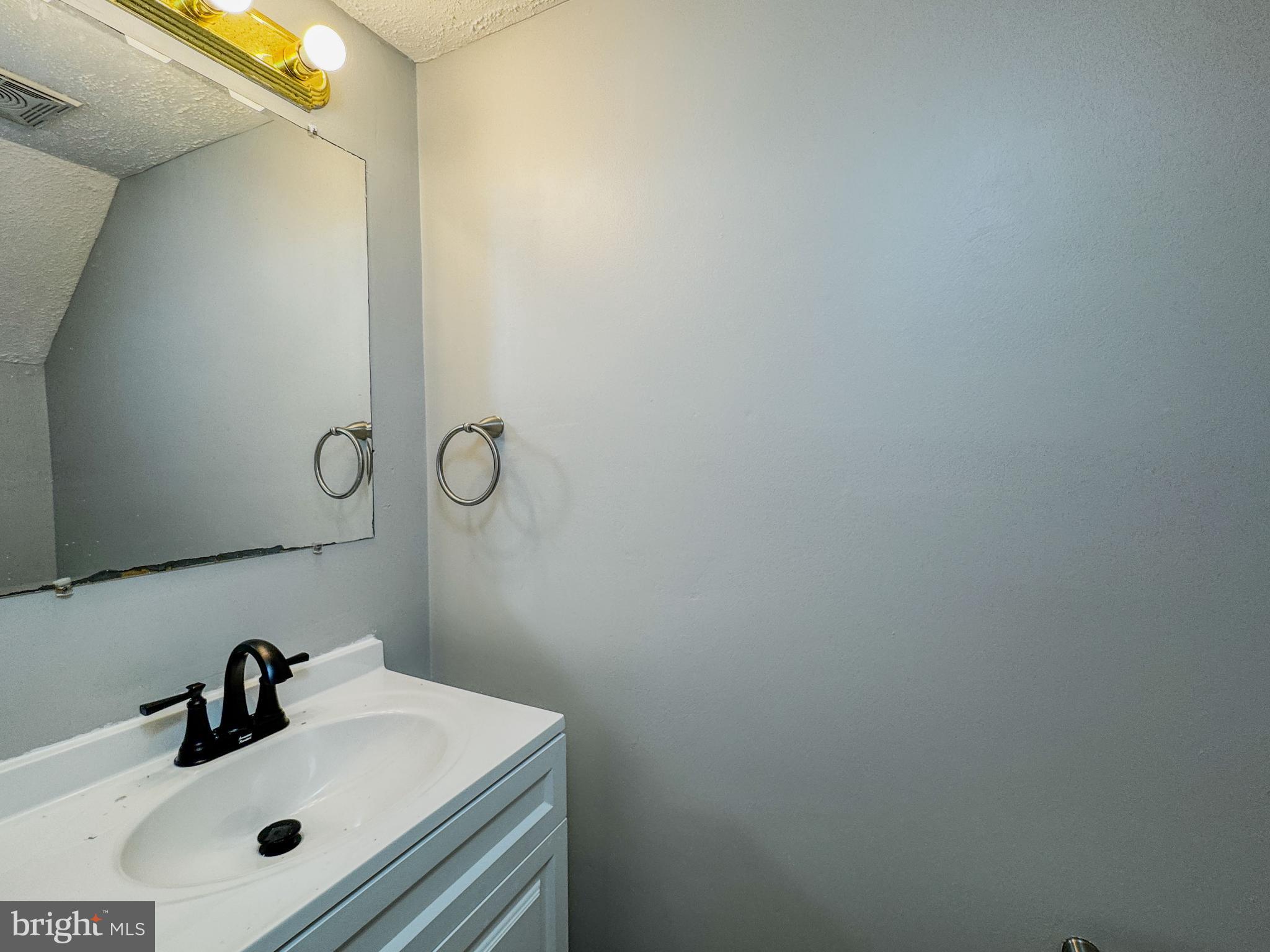 4 Milstone Court Sicklerville, NJ 08081 - Photo 10 of 23 a bathroom with a sink and mirror