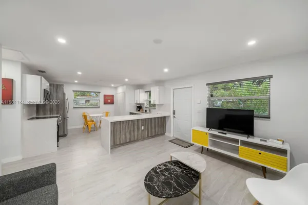 a living room with furniture and a flat screen tv