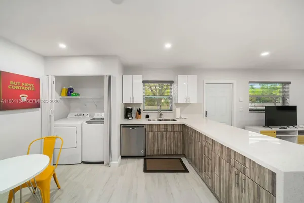 a kitchen with a sink appliances and cabinets