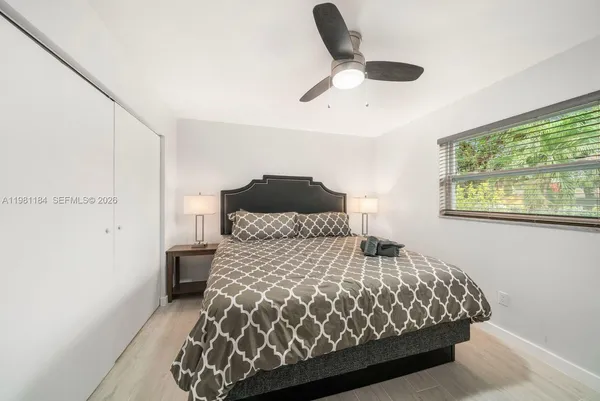 a bedroom with a large bed and a window