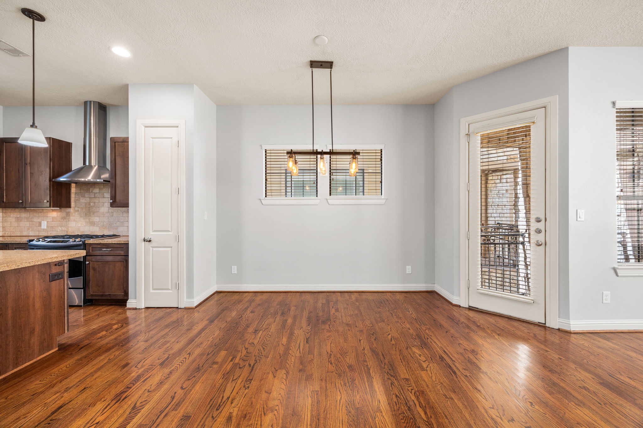 5213 Eigel Street, Unit A Houston, TX 77007 - Photo 12 of 30 a view of empty room with wooden floor and a window
