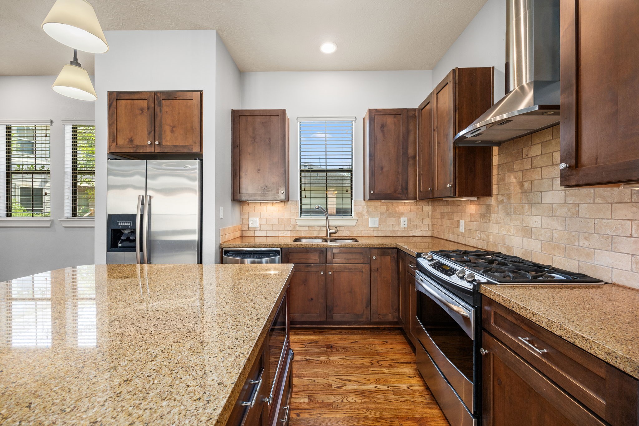 5213 Eigel Street, Unit A Houston, TX 77007 - Photo 15 of 30 a kitchen with stainless steel appliances granite countertop a stove sink and cabinets