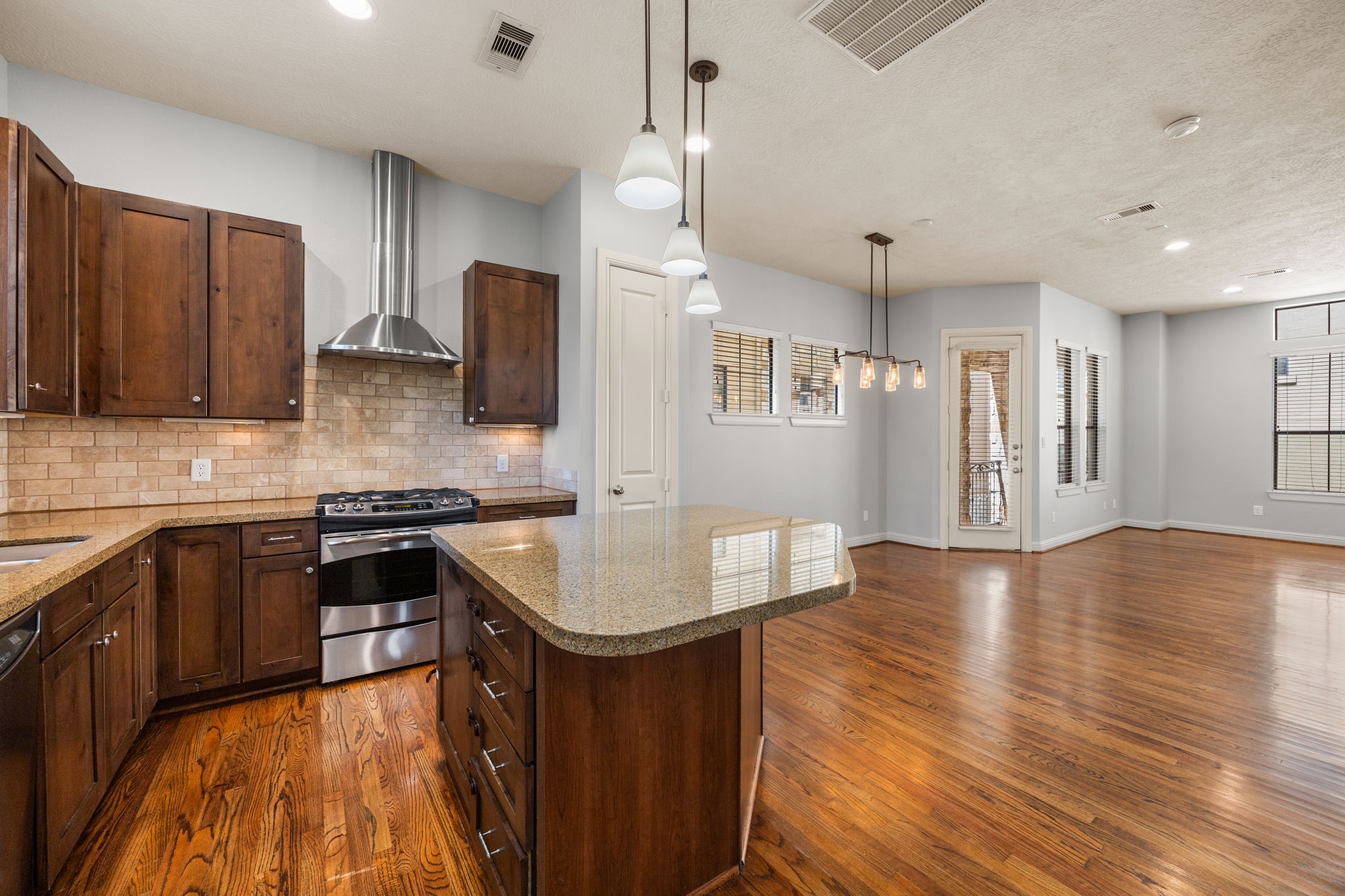 5213 Eigel Street, Unit A Houston, TX 77007 - Photo 16 of 30 a kitchen with stainless steel appliances granite countertop a sink a stove top oven a counter space and cabinets