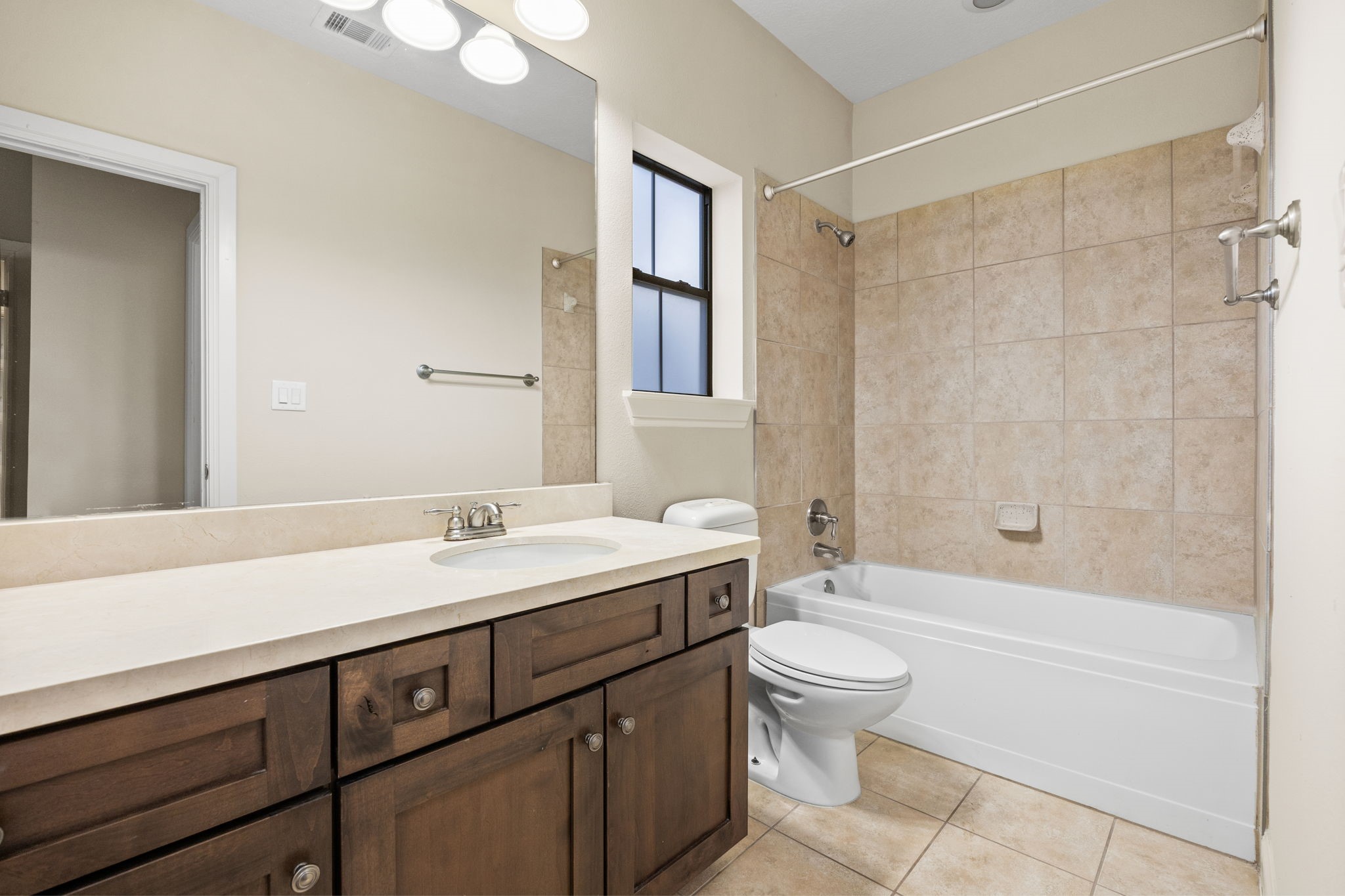 5213 Eigel Street, Unit A Houston, TX 77007 - Photo 26 of 30 a bathroom with a sink a toilet and a large mirror