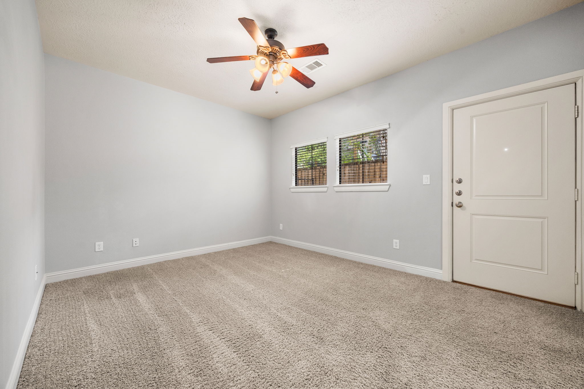 5213 Eigel Street, Unit A Houston, TX 77007 - Photo 6 of 30 an empty room with closet and ceiling fan