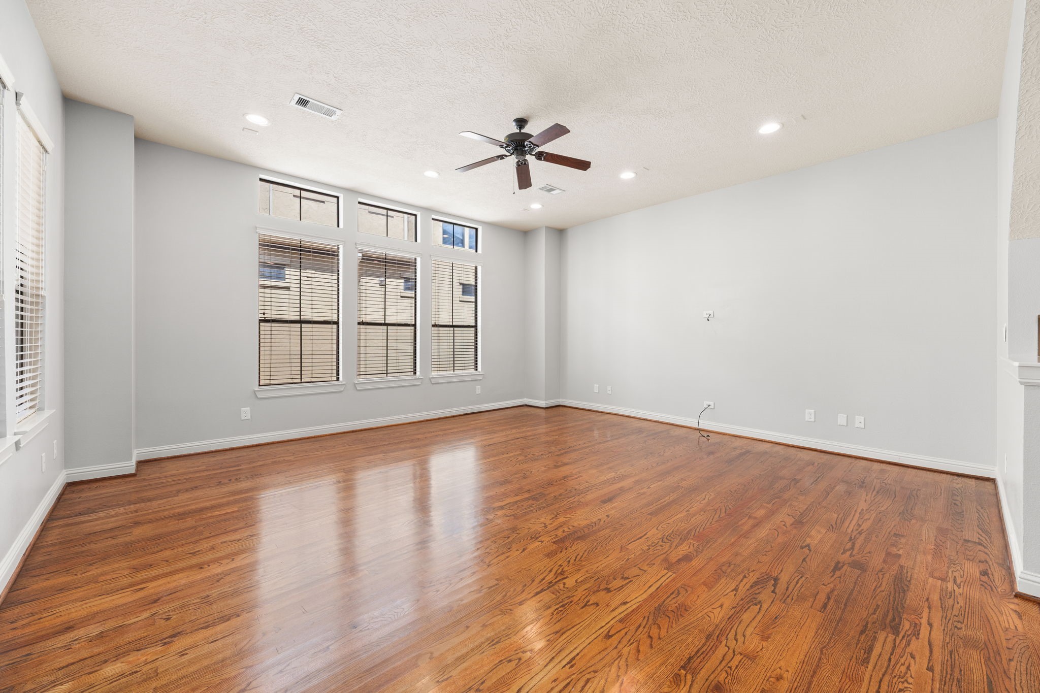 5213 Eigel Street, Unit A Houston, TX 77007 - Photo 10 of 30 wooden floor in an empty room with a window