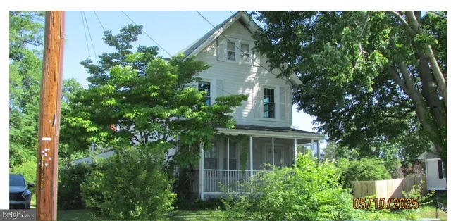 a front view of a house with plants