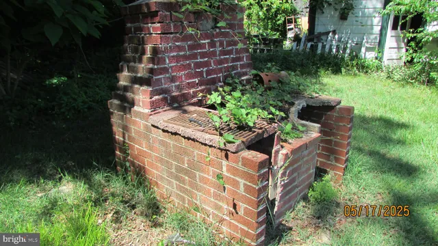 a front view of a house with a garden and trees