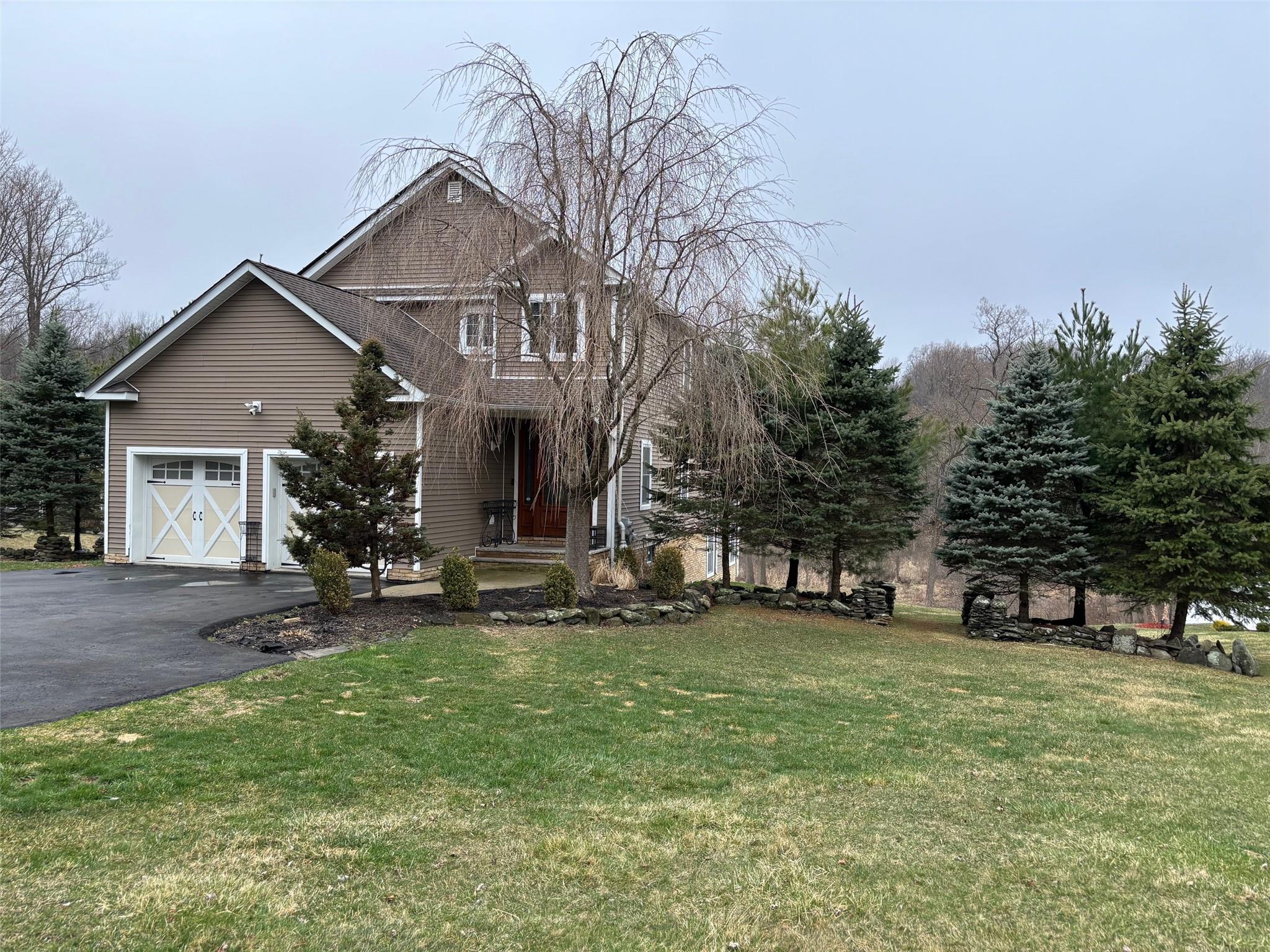 a view of a house with a yard and sitting area