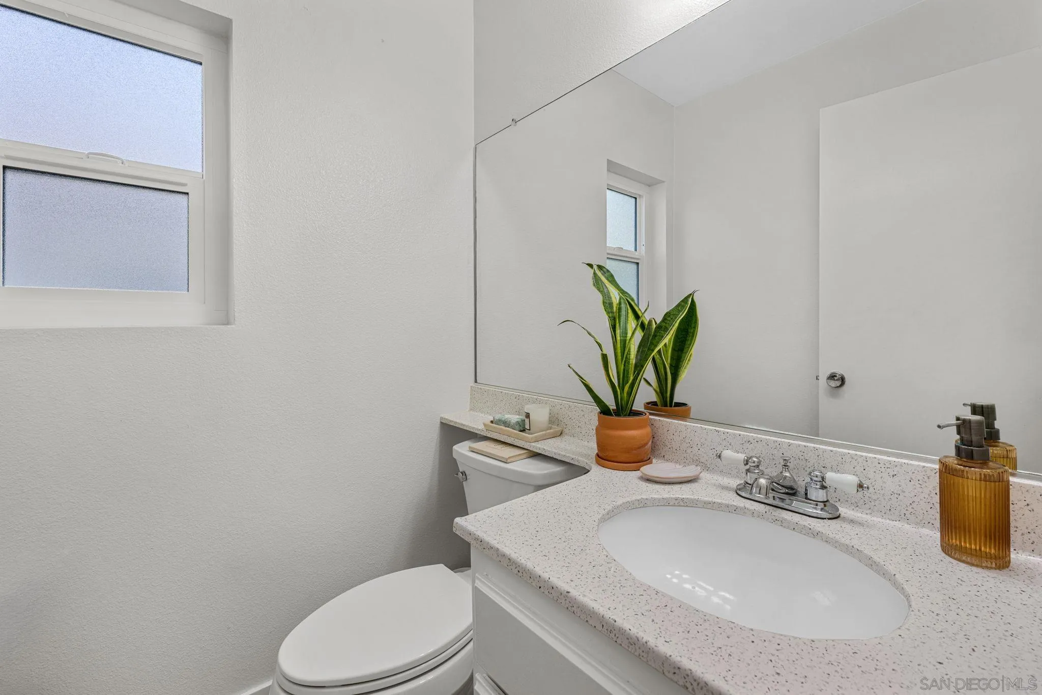5392 Blackberry Way Oceanside, CA 92057 - Photo 14 of 37 a bathroom with a granite countertop toilet sink and mirror