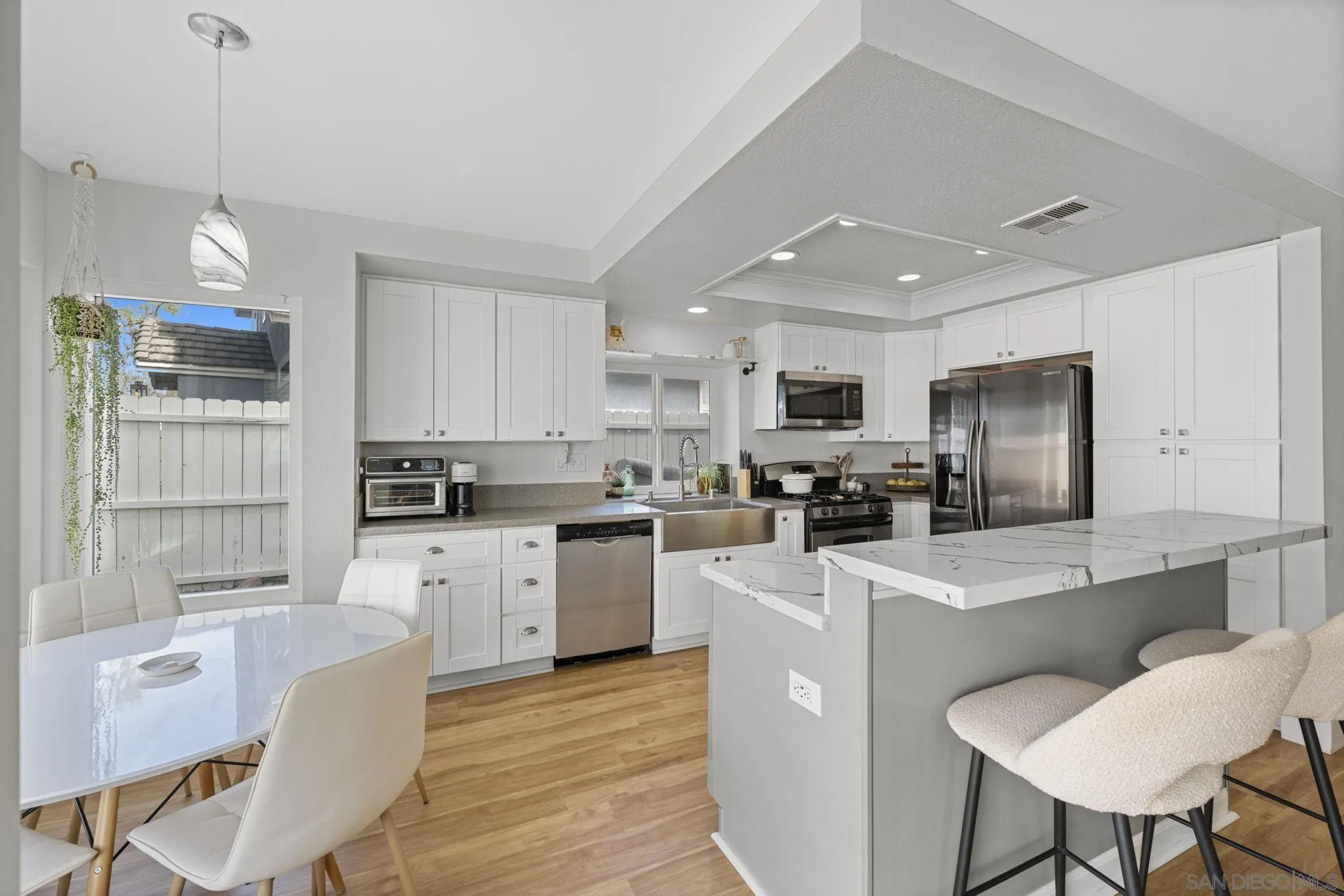 5392 Blackberry Way Oceanside, CA 92057 - Photo 15 of 37 a kitchen with sink a center island stainless steel appliances and cabinets