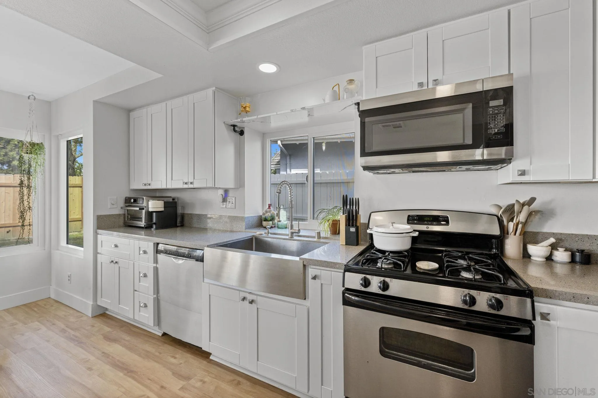 5392 Blackberry Way Oceanside, CA 92057 - Photo 17 of 37 a kitchen with stainless steel appliances white cabinets and a stove top oven