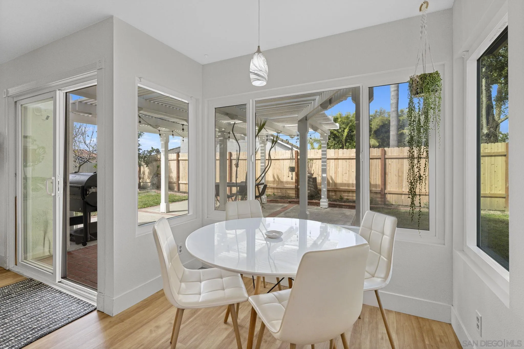 5392 Blackberry Way Oceanside, CA 92057 - Photo 19 of 37 a view of a dining room with furniture large windows and wooden floor