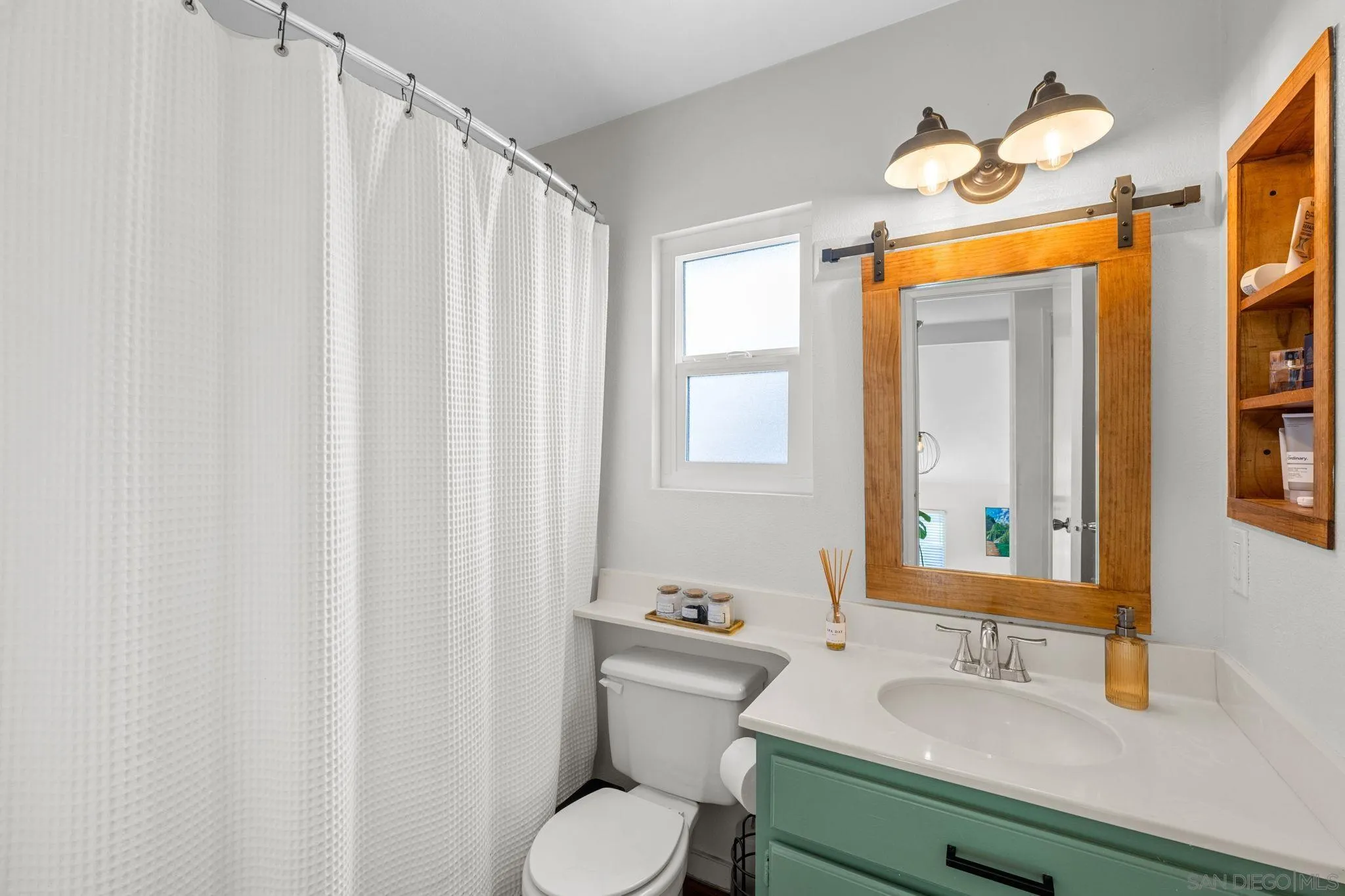 5392 Blackberry Way Oceanside, CA 92057 - Photo 24 of 37 a bathroom with a sink and a mirror