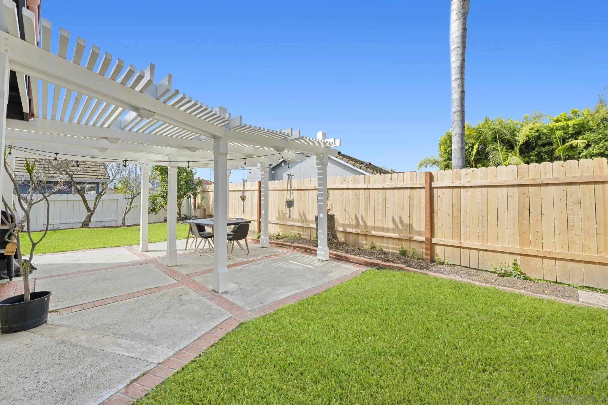 5392 Blackberry Way Oceanside, CA 92057 - Photo 31 of 37 a view of a backyard with couches under an umbrella