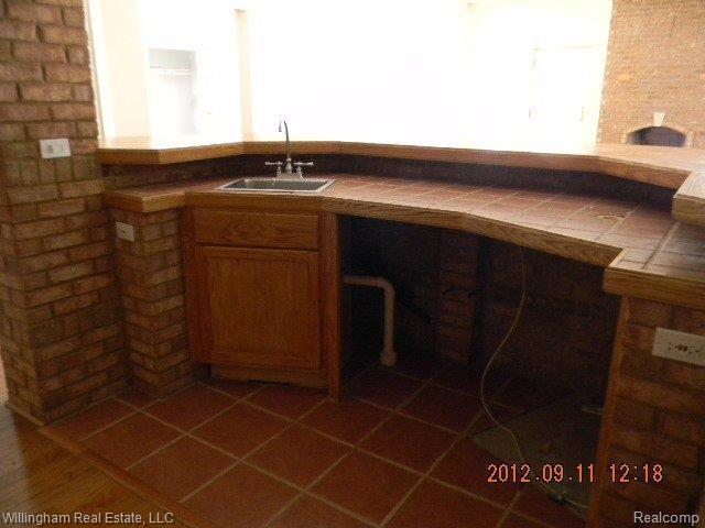 7151 Argentine Road Howell, MI 48855 - Photo 9 of 15 All brick wet bar in basement.JP