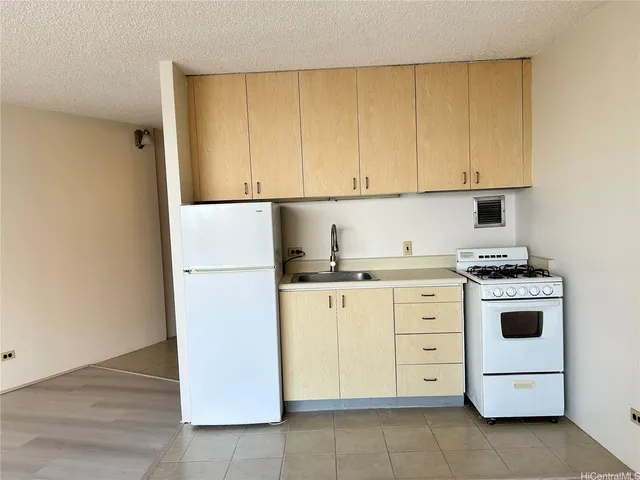 a view of a kitchen with wooden floor and a sink