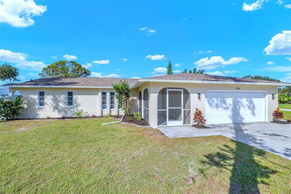 2640 Geneva Road Venice, FL 34293 - Photo 1 of 1 a view of a house with a yard and potted plants