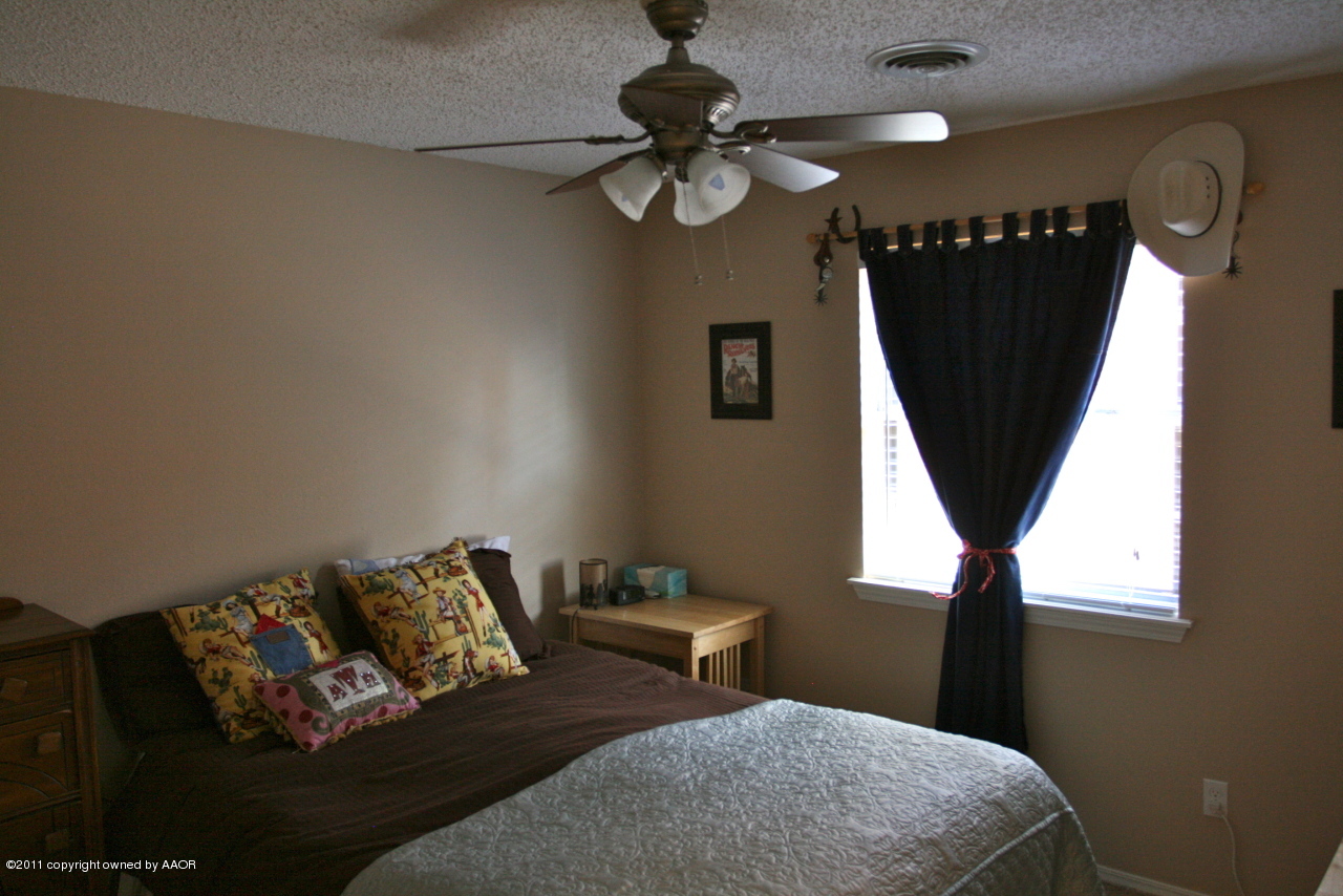 5332 Capulin Lane Amarillo, TX 79110 - Photo 2 of 10 a bedroom with furniture and a window