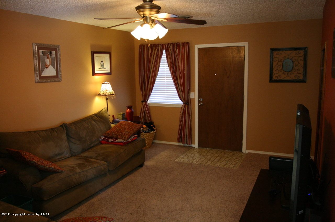 5332 Capulin Lane Amarillo, TX 79110 - Photo 6 of 10 a living room with furniture and a window