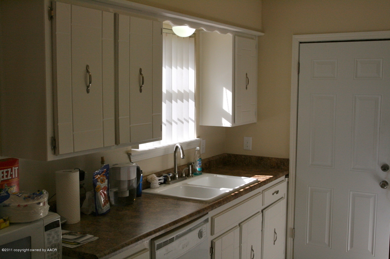 5332 Capulin Lane Amarillo, TX 79110 - Photo 7 of 10 a kitchen with a sink and cabinets