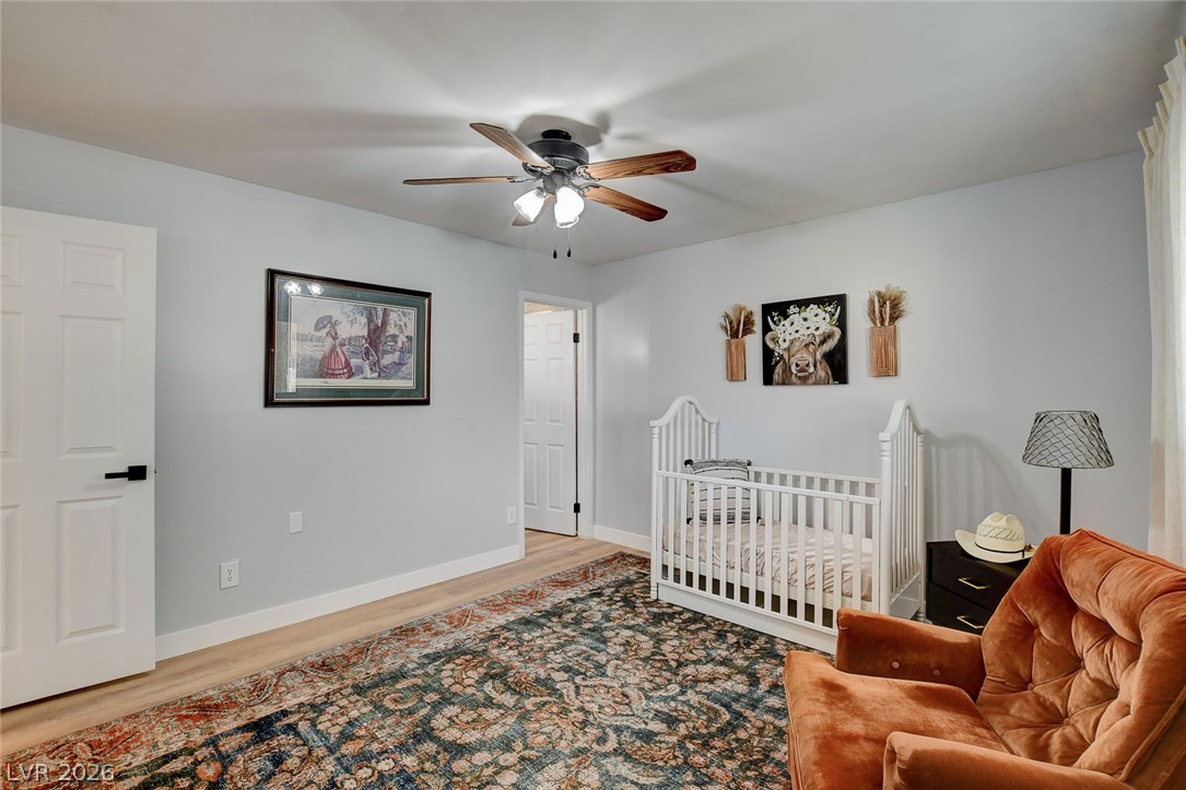 3765 Berkeley Street Logandale, NV 89021 - Photo 41 of 87 This bedroom features durable LVP flooring and a refreshing ceiling fan, ideal for relaxation.