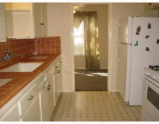 a bathroom with a granite countertop sink a mirror and a shower