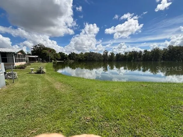 a view of a lake with a yard