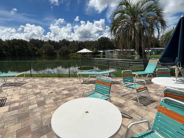 a view of a lake with a table and chairs