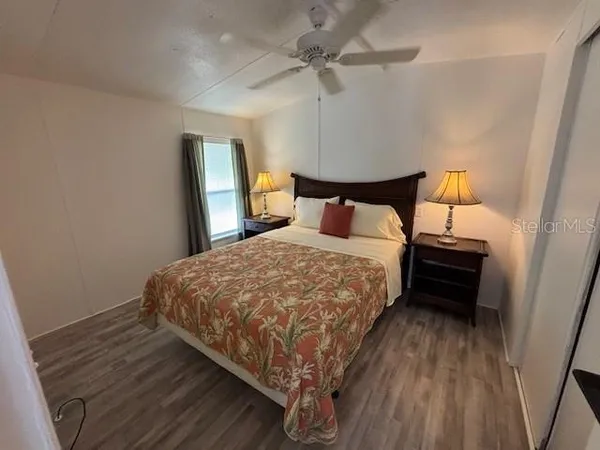 a bed sitting in a bedroom next to a lamp