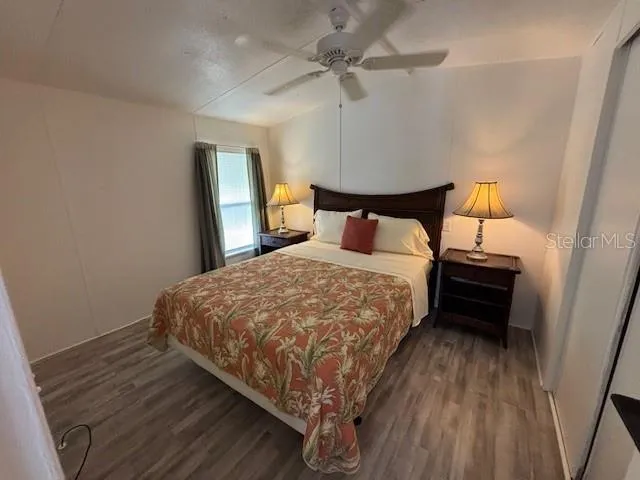 a bed sitting in a bedroom next to a lamp