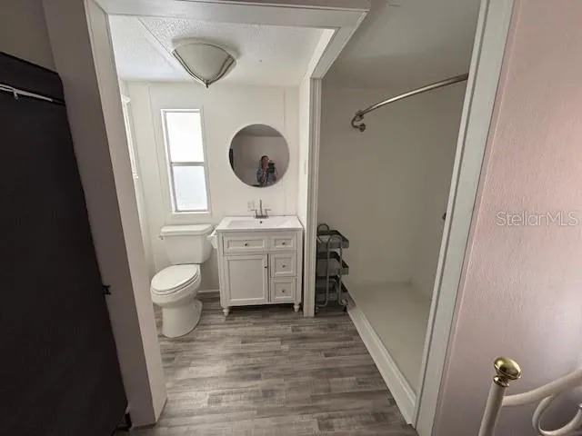 a bathroom with a toilet a sink and a mirror