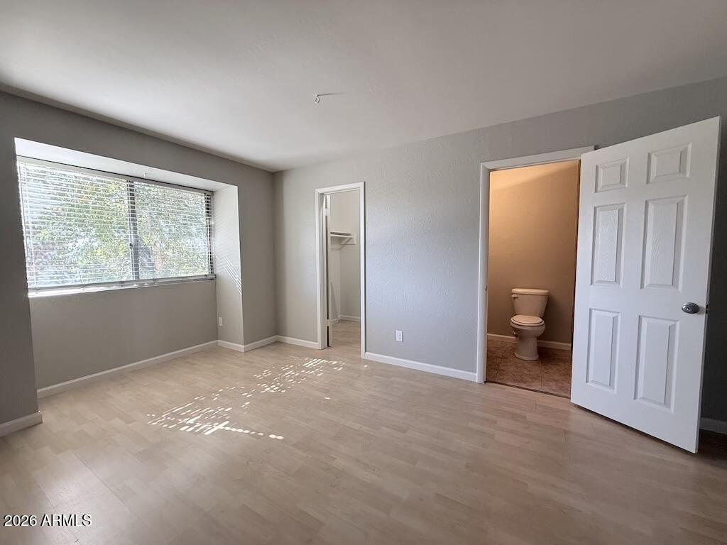 1004 East Osborn Road, Unit E Phoenix, AZ 85014 - Photo 6 of 32 a view of an empty room with a window